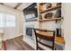 Living room featuring built-in shelves, decorative fireplace, and adjacent work space with dark wood flooring at 309 E End Ave, Durham, NC 27703