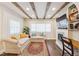Cozy living room with beamed ceilings, an electric fireplace, built-in shelves, and comfortable seating near bright windows at 309 E End Ave, Durham, NC 27703