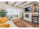 Comfortable living room with beamed ceiling, fireplace, large window, and a cozy seating arrangement with stylish decor at 309 E End Ave, Durham, NC 27703
