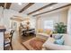 Open living space featuring wood beam ceilings, hardwood floors, and an archway to the dining and kitchen areas at 309 E End Ave, Durham, NC 27703