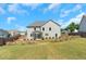 Back exterior of the home with a fence, landscaping, and a well-manicured lawn at 315 Sugarpine Trl, Clayton, NC 27520