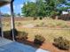 Well-maintained backyard with a fence, landscaping, and a covered porch at 315 Sugarpine Trl, Clayton, NC 27520