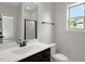 Bright bathroom with a large mirror, walk-in shower, and natural light at 315 Sugarpine Trl, Clayton, NC 27520