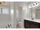 Bright bathroom with a soaking tub, dark cabinets, tile floor, and natural light at 315 Sugarpine Trl, Clayton, NC 27520