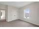 Neutral bedroom with carpet, double closet doors, one window providing ample light, and white trim at 315 Sugarpine Trl, Clayton, NC 27520
