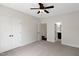 Spacious bedroom featuring carpet, a ceiling fan, and closet with double doors at 315 Sugarpine Trl, Clayton, NC 27520