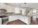 Beautiful kitchen with granite counters, stainless steel appliances, and white cabinets, open to the staircase at 315 Sugarpine Trl, Clayton, NC 27520