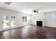 Open-concept living room featuring hardwood floors, a fireplace and french doors leading to the outdoors at 315 Sugarpine Trl, Clayton, NC 27520