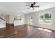 Bright living room with hardwood floors, a ceiling fan, and large windows that let in natural light at 315 Sugarpine Trl, Clayton, NC 27520