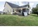 A well-maintained backyard with green lawn and a patio featuring a hot tub and seating area at 3441 Jordan Shires Dr, New Hill, NC 27562