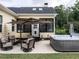 Backyard patio area with an umbrella-covered table, hot tub, and manicured lawn at 3441 Jordan Shires Dr, New Hill, NC 27562