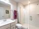Bright bathroom features a tiled shower with glass door and white marble vanity top at 3441 Jordan Shires Dr, New Hill, NC 27562