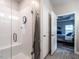 Renovated bathroom with walk-in shower, glass doors, and adjacent bedroom at 3441 Jordan Shires Dr, New Hill, NC 27562