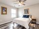 Charming bedroom with wood floors, artwork, a ceiling fan, and a bright window at 3441 Jordan Shires Dr, New Hill, NC 27562