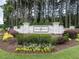 A beautifully landscaped entrance sign for Jordan Pointe, surrounded by lush greenery and flowers at 3441 Jordan Shires Dr, New Hill, NC 27562