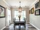 Charming dining room with modern chandelier, decor, and lots of natural light at 3441 Jordan Shires Dr, New Hill, NC 27562