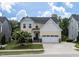 Charming two-story home featuring a well-manicured lawn, flowering tree, and a classic facade at 3441 Jordan Shires Dr, New Hill, NC 27562
