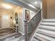 Elegant foyer with wood-look floors, staircase with black railings, and stylish decor at 3441 Jordan Shires Dr, New Hill, NC 27562
