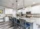 Modern kitchen featuring white cabinets, a granite island with seating, and stainless steel appliances at 3441 Jordan Shires Dr, New Hill, NC 27562