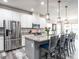 Well-equipped kitchen with a large island, stainless steel appliances, and abundant cabinet space at 3441 Jordan Shires Dr, New Hill, NC 27562