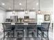 Spacious kitchen island with barstool seating, pendant lights, and a stylish countertop at 3441 Jordan Shires Dr, New Hill, NC 27562