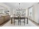 Elegant dining room with wooden table, stylish chairs, modern decor, and lots of natural light creating an inviting atmosphere at 361 Catheys Creek Cir, Wendell, NC 27591