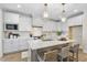 Bright kitchen featuring white cabinets, a central island with seating, and modern pendant lighting creating an inviting space at 361 Catheys Creek Cir, Wendell, NC 27591