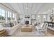 Bright and airy living room featuring coffered ceilings, a fireplace, comfortable seating, and plenty of natural light at 361 Catheys Creek Cir, Wendell, NC 27591