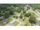 Lush aerial view showcases the home nestled among mature trees in a serene neighborhood setting near roadways at 409 Trail Two, Burlington, NC 27215