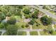 Expansive aerial view of a well-maintained home with mature trees, a green lawn, and neighborhood streets nearby at 409 Trail Two, Burlington, NC 27215