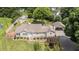 Aerial view of a home featuring well-manicured lawn, carport, fenced yard and separate storage building at 409 Trail Two, Burlington, NC 27215