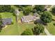 Aerial view of charming home with a fenced yard, a shed, mature trees, and a carport at 409 Trail Two, Burlington, NC 27215