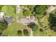 Aerial view highlighting the home with outbuildings, landscaping, and ample yard space at 409 Trail Two, Burlington, NC 27215