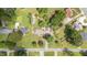 Aerial shot displaying the home's well-manicured lawn, garden, and surrounding trees in a neighborhood setting at 409 Trail Two, Burlington, NC 27215