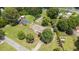 An aerial view of a home with fenced yard, mature trees, and a detached carport at 409 Trail Two, Burlington, NC 27215