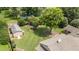 Aerial view of the property highlighting the expansive backyard, outbuildings and lush greenery at 409 Trail Two, Burlington, NC 27215