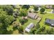 Aerial view showcasing the home, landscaped yard, outbuildings and the surrounding neighborhood at 409 Trail Two, Burlington, NC 27215