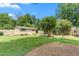 Backyard shed with ample storage, nestled among trees, in the lush green backyard at 409 Trail Two, Burlington, NC 27215
