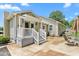 Backyard patio with outdoor seating, landscaped garden, and a charming home exterior at 409 Trail Two, Burlington, NC 27215