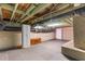 Basement with open ceiling, storage cabinet, rubber flooring, and potential for customization at 409 Trail Two, Burlington, NC 27215