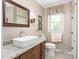 Bathroom featuring a vessel sink atop a wooden vanity with granite counters and neutral paint at 409 Trail Two, Burlington, NC 27215