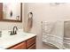 Bathroom featuring a vanity with bronze fixtures, neutral walls, a large mirror, and clean towels at 409 Trail Two, Burlington, NC 27215