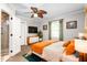 Bright bedroom with ceiling fan, TV, ensuite bathroom, and a modern dresser at 409 Trail Two, Burlington, NC 27215
