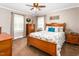 Cozy bedroom features a classic wooden bed frame, bright windows, and decorative accents at 409 Trail Two, Burlington, NC 27215