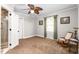 Spacious bedroom with neutral carpet, ceiling fan, and view into an ensuite bathroom at 409 Trail Two, Burlington, NC 27215
