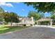Exterior side view of home featuring mature landscaping and a gravel carport area at 409 Trail Two, Burlington, NC 27215