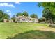 Charming single-story home with well-maintained front yard and mature shade trees at 409 Trail Two, Burlington, NC 27215
