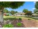 Home featuring mature landscaping, an American flag, and a gravel driveway with a carport at 409 Trail Two, Burlington, NC 27215