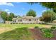 Charming home featuring a well-maintained lawn, mature landscaping, and covered front porch at 409 Trail Two, Burlington, NC 27215