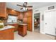 View of the kitchen featuring wooden cabinets, a granite countertop island, and an open doorway to the dining room at 409 Trail Two, Burlington, NC 27215